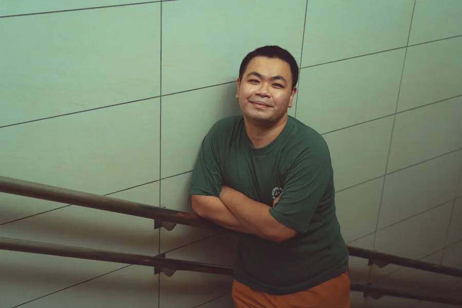 Traveler standing beside an indoor railing