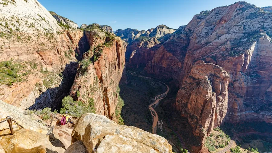 Hikers navigating the narrow chain section of Angels Landing trail in Zion National Park