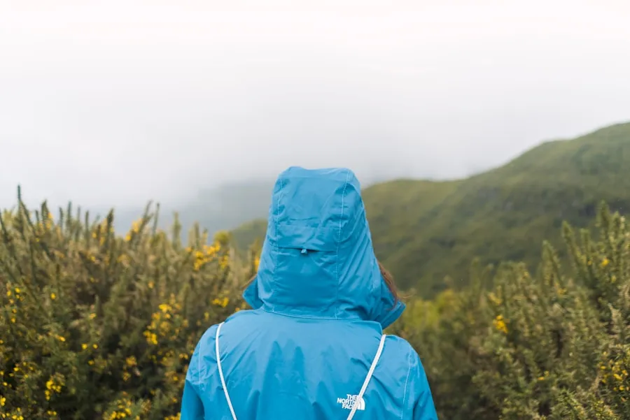 Hiker dressed for changing mountain weather conditions