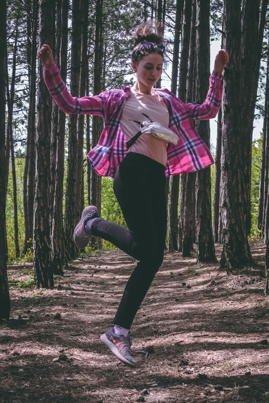 Hiker wearing layered outdoor clothing suitable for changing trail conditions