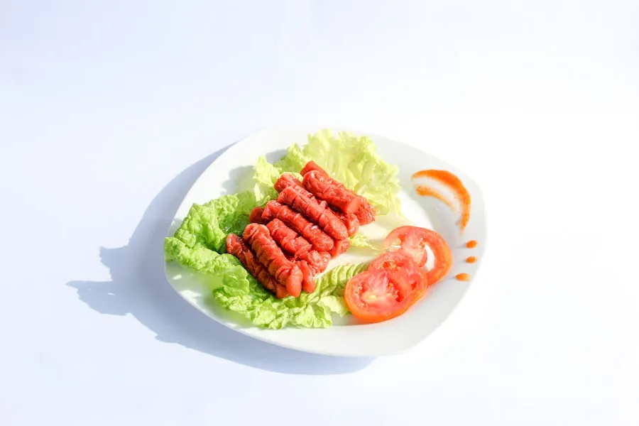 A seared airline chicken breast with the drumette bone attached, plated with sauce and garnish