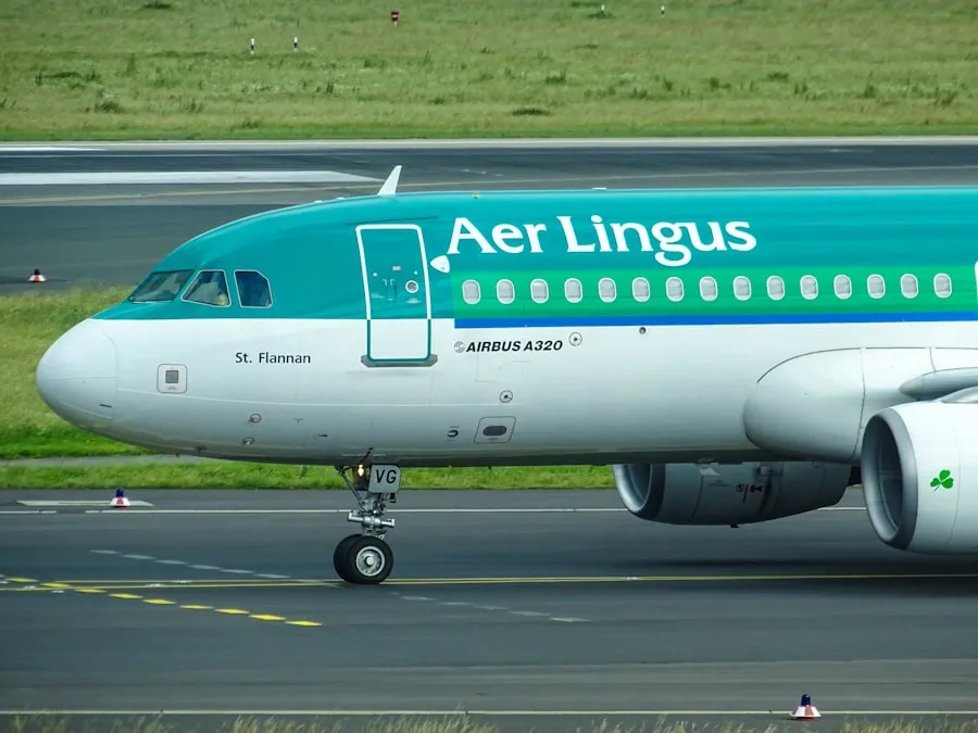 Aer Lingus Airbus passenger aircraft parked at airport terminal gate undergoing pre-flight safety inspections