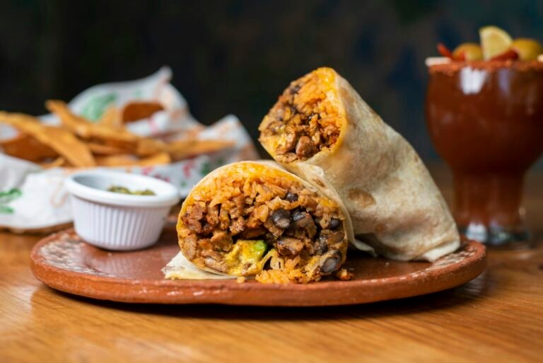 Best Restaurants in San Francisco, California: Where to Eat Now Burrito with chips and salsa on a wooden plate
