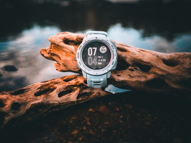 Best Hiking Watches Rugged GPS outdoor watch resting on driftwood