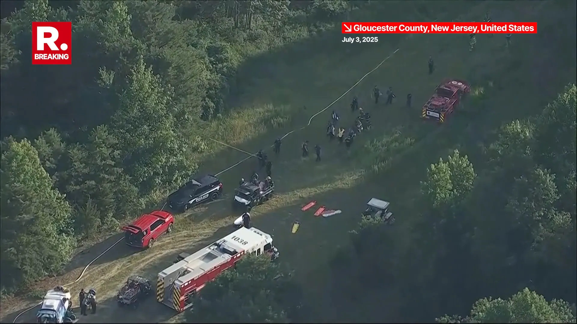 Breaking: Skydiving Plane Crashes Into Woods Near New Jersey Airport, 15 Injured Fire trucks lined up near crash site