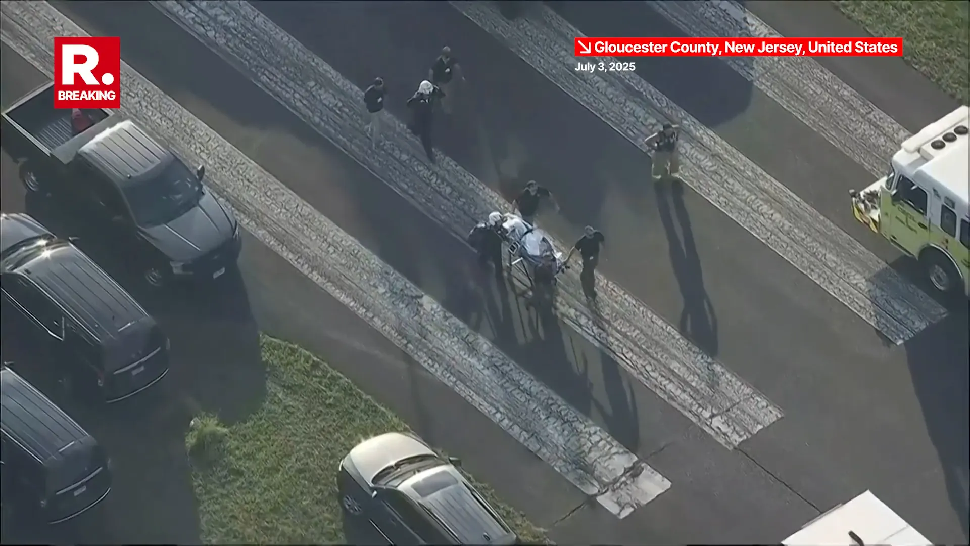Breaking: Skydiving Plane Crashes Into Woods Near New Jersey Airport, 15 Injured Emergency responders transporting injured on stretchers